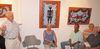 Dr Andrew Binns speaking at the artist’s talk by Bundjalung painter Adrian Cameron (third from right), whose works are on display at Lismore Regional Art Gallery. At right is his former probation and parole officer, Patrick Coughlan.