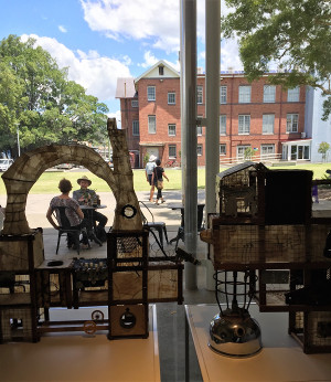 With the Lismore Library as a backdrop, café patrons are seen through Leora Sibony’s work ‘Basic Forms’ (found objects, metal, wood, 2017), part of her exhibition Industrial Relations.