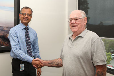 Dr Sagar Ramani and Mr William Wallace meeting for a follow up appointment one month after receiving SABR treatment for lung cancer.