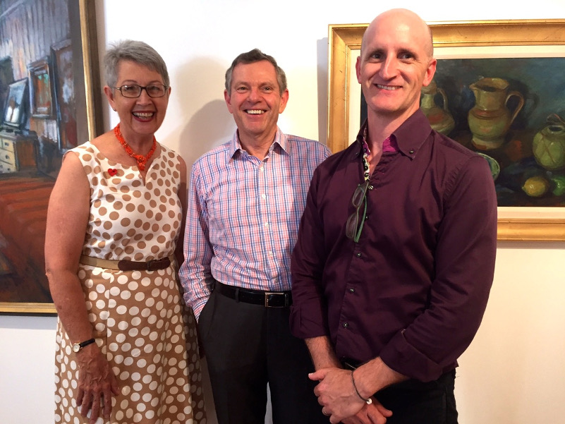 Lismore Mayor Jenny Dowell, Margaret Olley Trust representative Phillip Bacon, and Lismore Regional Gallery director Brett Adlington. Works by Olley from the gallery’s collection include (left) Spare Bedroom (1970) and Lemons and Ginger Jar (c1980