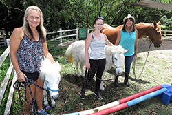 Pictured at the Horses Helping Humans property in the Gold Coast hinterland are (l-r) Narelle van Egmond, Scottish born jockey Gina Mitchell, badly injured in a race fall, and program founder Sue Spence.