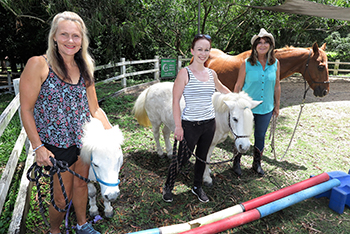 Pictured at the Horses Helping Humans property in the Gold Coast hinterland are (l-r) Narelle van Egmond, Scottish born jockey Gina Mitchell, badly injured in a race fall, and program founder Sue Spence.