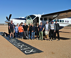 Pictured at William Creek airfield before flying over Kati Thander-Lake Eyre, now in a dramatic flood phase, are (l-r) Seair Pacific pilot and guide Kirk Campbell, Ruth Tinker, Susan Brown, Jane Griffin, John Haggerty, Andrew Binns, Jeni Binns, Emily Yorston, Mark Hartcher, Maree Beek, Jurriaan Beek, and pilot and GP Izaac Flanagan.